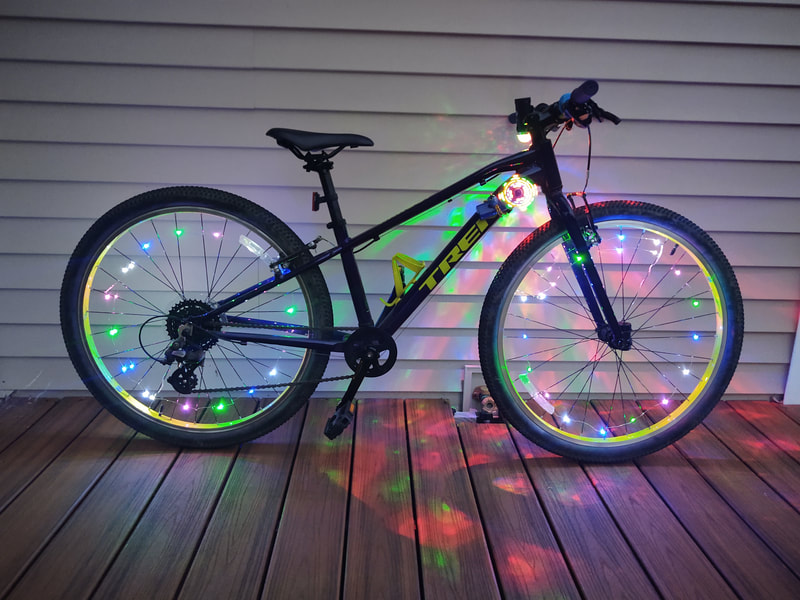 ARRIVE with your walking stick, bike, scooter, stroller,
or skateboard DECORATED with lights, glow-in-the-dark accessories,
and or battery operated lights.
